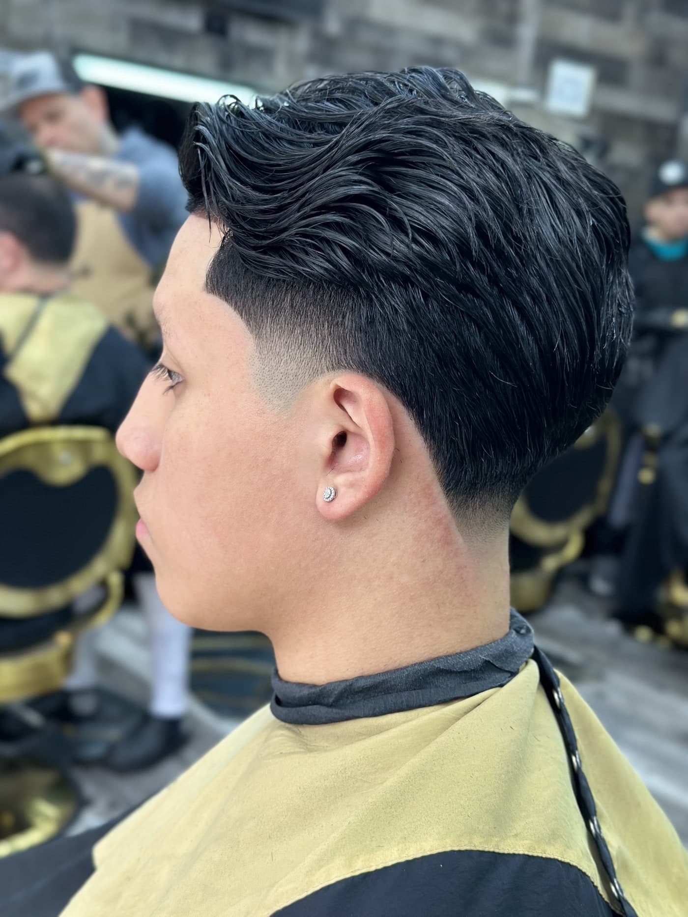 Slicked back taper haircut at Traggocuts
